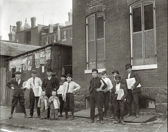 Photo showing: Basement Branch Newsies -- May 1910. St. Louis, Missouri. Johnnie Burns and his Basement Branch.
Burns says the 4-year-old twins will be selling soon. 3518 Evans Avenue.