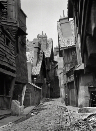 Photo showing: Rags, Bones, Bottles -- Circa 1920. Unidentified buildings, possibly movie set, associated with Famous Players-Lasky.