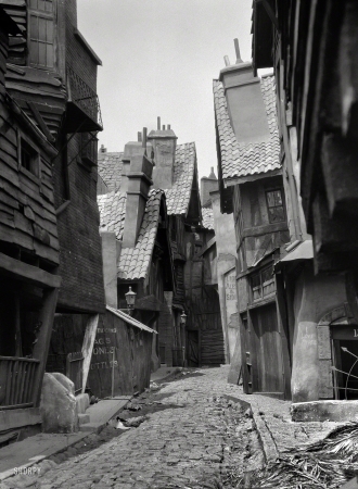 Photo showing: Rags, Bones, Bottles -- Circa 1920. Unidentified buildings, possibly movie set, associated with Famous Players-Lasky.