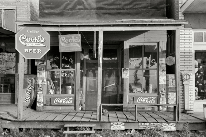 Photo showing: Beware of Cat -- September 1938. Storefront in Altheimer, Arkansas.