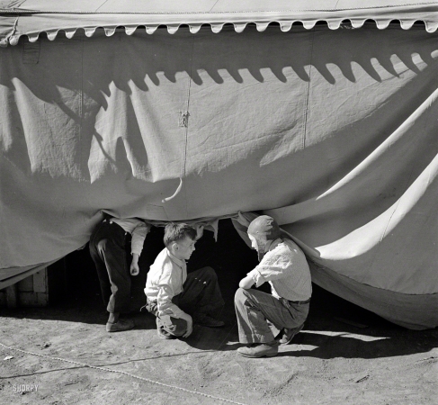Photo showing: A Pair of Sneakers -- April 1936. Sneaking under the circus tent. Roswell, New Mexico.