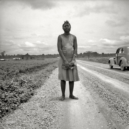 Photo showing: Sunday Best -- July 1936. Mississippi Delta. Negro woman carrying her shoes home from church.