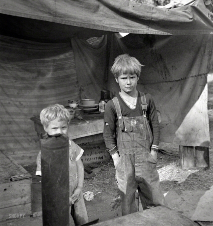 Photo showing: When I Was a Kid -- November 1936. American River camp near Sacramento, California.
Children of destitute family. Five children aged two to seventeen.