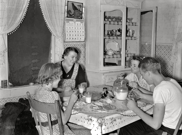 Photo showing: Family Dinner -- May 1940. Mrs. Marinus W. Hansen, wife of Farm Security Administration
rehabilitation farmer in Box Elder County, Utah, has dinner with her three children.
