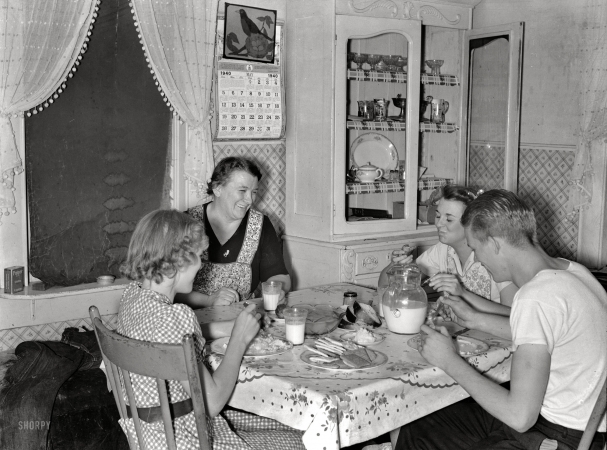 Photo showing: Family Dinner -- May 1940. Mrs. Marinus W. Hansen, wife of Farm Security Administration
rehabilitation farmer in Box Elder County, Utah, has dinner with her three children.