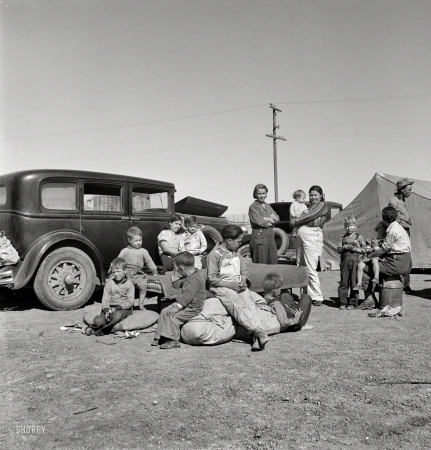 Photo showing: Are We There Yet? -- March 1937. Four families, three of them related with 15 children, from the Dust Bowl
in Texas in an overnight roadside camp near Calipatria, California.