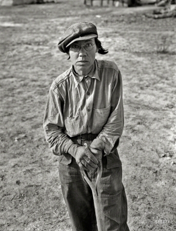 Photo showing: Shovel-Ready -- February 1937. Calipatria, California. Native of Indiana in a migratory labor contractor's camp. It's root hog or die for us folks.