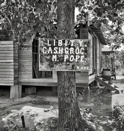 Photo showing: The Tree of Libity -- June 1937. Mississippi grocery store.