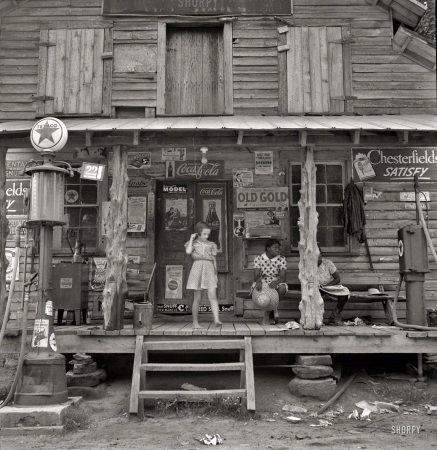 Photo showing: Country Store -- July 1939. Daughter of white tobacco sharecropper at country store. Person County, North Carolina.