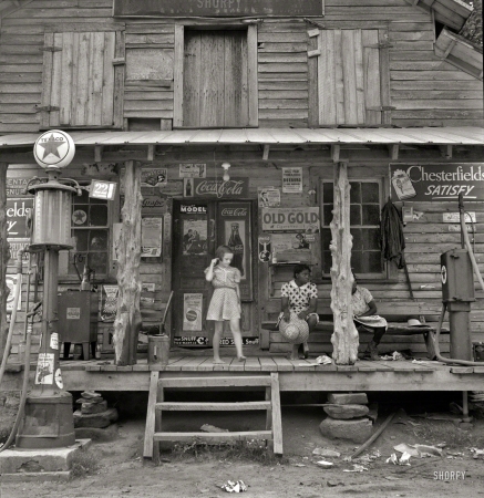 Photo showing: Country Store -- July 1939. Daughter of white tobacco sharecropper at country store. Person County, North Carolina.