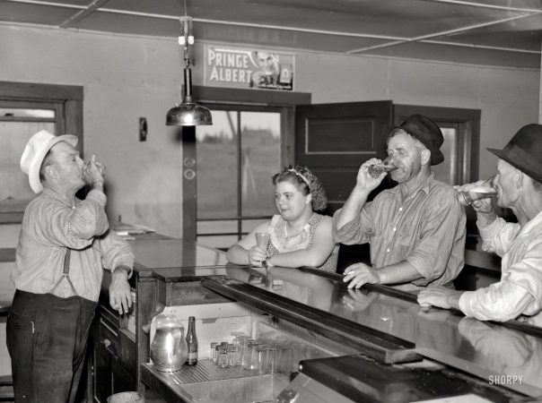 Photo showing: A Round on the House -- August 1937. A drink on the house. Lumberjacks, proprietor and lady attendant in saloon. Craigville, Minnesota.