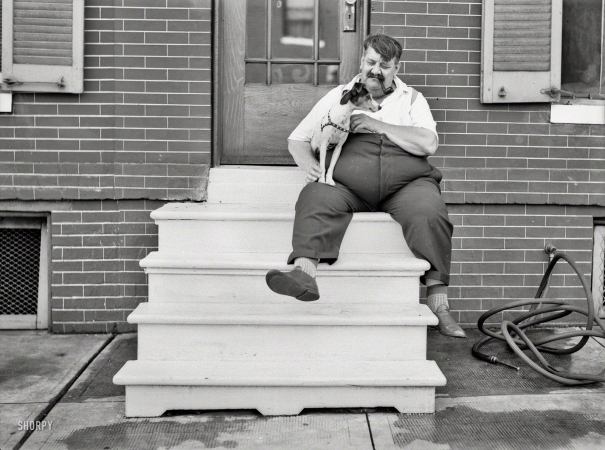 Photo showing: And His Little Dog, Too -- July 1938. Man who lives in row house. Baltimore, Maryland.
