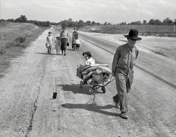 Photo showing: Bound for Krebs -- June 1938. Pittsburg County, Oklahoma. Family walking on highway, five children. Started from Idabel, bound for Krebs.