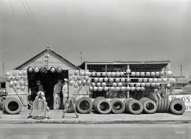 Photo showing: Hubcap Heaven -- February 1939. Auto parts store in Corpus Christi, Texas.