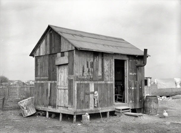 Photo showing: Beware of Duck -- March 1939. House in Mexican section made of discarded airplane engine crates. San Antonio, Texas.