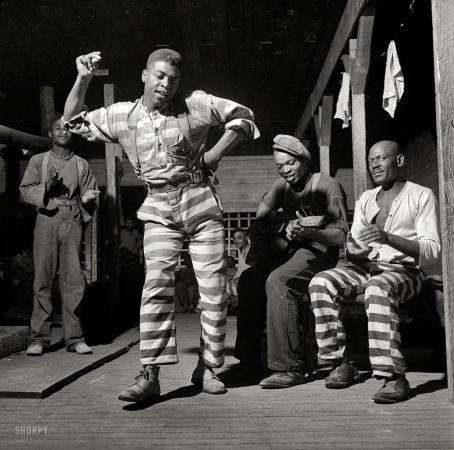 Photo showing: Blues in the Night -- May 1941. In the convict camp at Greene County, Georgia. The guitarist is bluesman Buddy Moss.