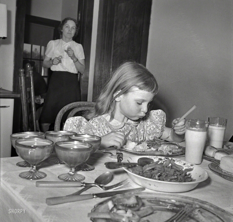 Photo showing: Save Room for Dessert -- Spring 1942. Little girl on a farm in Maryland, learning to eat vitamins.