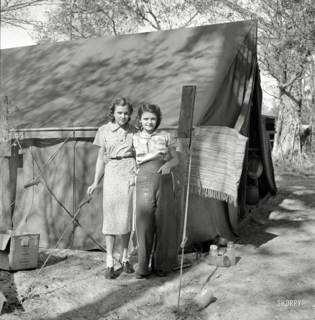 Photo showing: Packinghouse Pair -- February 1939. Migrant labor. Young packinghouse workers in tent camp. Canal Point, Florida.