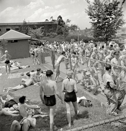 Photo showing: Adult Swim -- July 1942. Sunbathers on the grass next to the municipal swimming pool on Sunday.