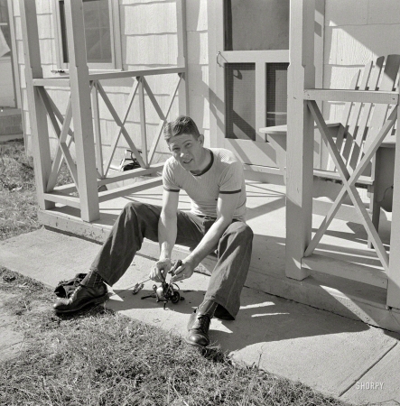 Photo showing: Porch Mechanic -- October 1941. Radford, Virginia. Sunset Village, FSA housing project. Fred B. Williams from
Savannah, Georgia, cleaning car distributor on the porch of his home, 803 9th Street.