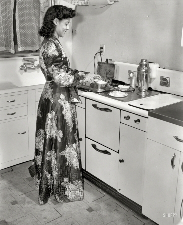 Photo showing: Jewel in the Kitchen -- Winter 1942. Washington, D.C. Jewel Mazique, worker at the Library of Congress, getting a late snack.