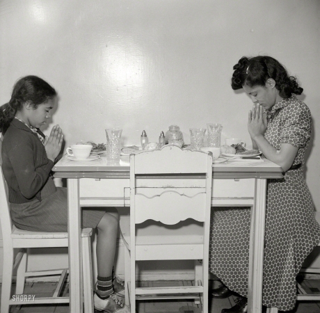 Photo showing: Asking the Blessing -- March 1942. Washington, D.C. After a hard day's work in the Library of Congress, Jewel Mazique sits down to dinner with her niece.