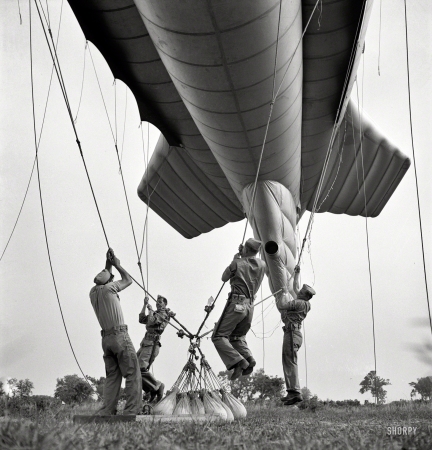 Photo showing: How to Bed a Balloon -- May 1942. Parris Island, South Carolina. Special Marine units learning how to bed down a big barrage balloon.