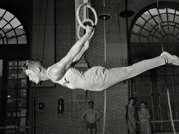 Photo showing: Navy Flier -- July 1942. U.S. Naval Academy, Annapolis, Md. Gymnast on the flying rings.
