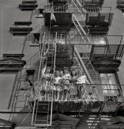 Photo showing: The Summer of  42 -- Italian girls watching flag raising ceremony in honor of neighborhood boys in the U.S. Army, New York, August 1942.