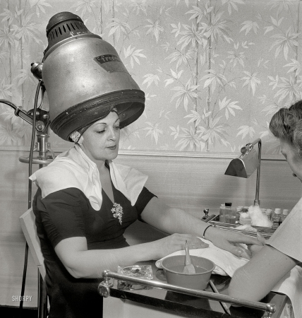 Photo showing: The Full Treatment: 1942 -- Getting a manicure while drying hair at Francois de Paris, a hairdresser on West Eighth Street, New York.