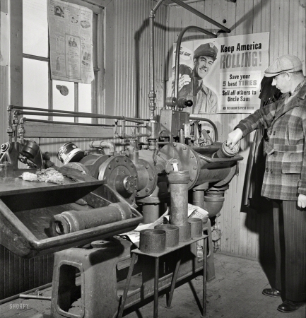 Photo showing: Instant Message -- November 1942. Chicago, Illinois. These pneumatic tubes in the Illinois Central
Railroad yardmaster's office connect him with the general office. 