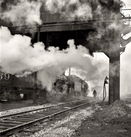 Photo showing: Coal, Water, Sand -- November 1942. Chicago. Locomotives loading up with coal, water and sand at an Illinois Central Railroad yard.