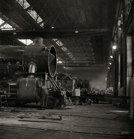 Photo showing: Iron Dinosaur -- December 1942. Chicago, Illinois. Locomotive at the Chicago & North Western Railroad repair shops.