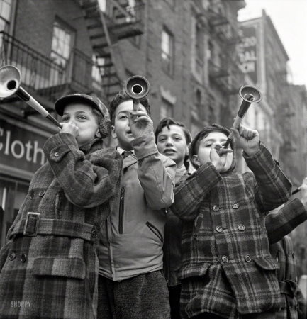 Photo showing: Happy New Year -- January 1, 1943. New York. Blowing horns on Bleecker Street on New Year's Day.