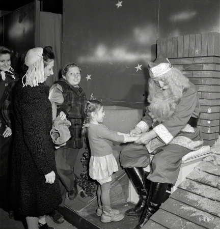 Photo showing: Secret Santa -- December 1942. New York. Macy's department store. There are two Santas,
concealed from one another by a labyrinth to prevent disillusionment of the children.