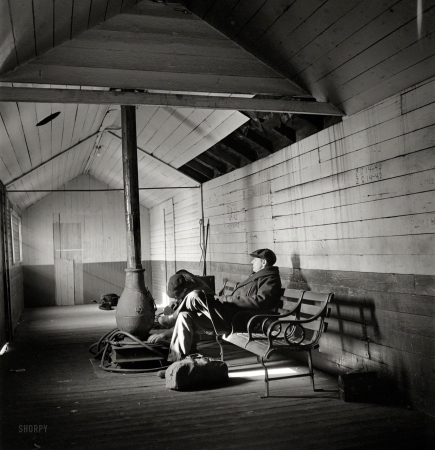 Photo showing: Cozy Depot -- January 1943. Freight operations on the Chicago & North Western.
Conductor John Wolfsmith waits for a suburban train to take him back home to Chicago.