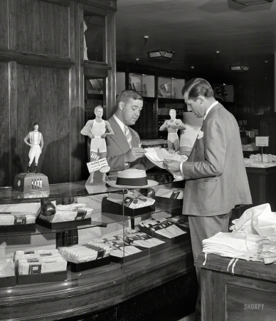 Photo showing: Shorts Seller -- July 1941. Detroit, Michigan. Buying men's shorts in the Crowley-Milner department store.