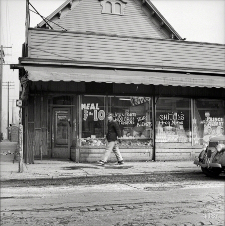 Photo showing: Liver & Lights -- February 1942. Detroit, Michigan. Sign in a grocery window in the Negro district: 'chitlins and hog maws'.