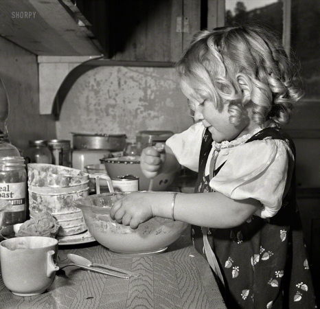 Photo showing: Mixmistress Mutz -- February 1943. Moreno Valley, Colfax County, New Mexico.
George Mutz's youngest daughter helping with the cooking.