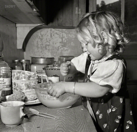 Photo showing: Mixmistress Mutz -- February 1943. Moreno Valley, Colfax County, New Mexico.
George Mutz's youngest daughter helping with the cooking.