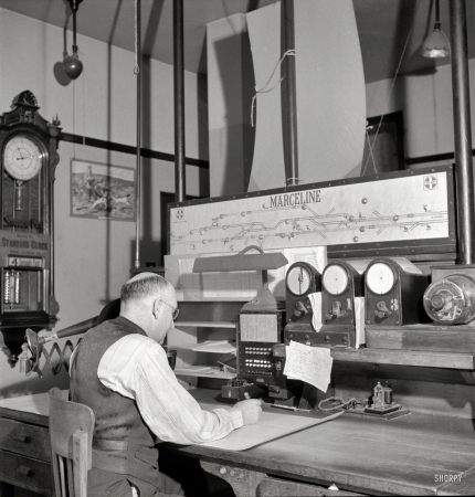 Photo showing: Mission Control -- March 1943. Marceline, Missouri. A dispatcher in the Atchison, Topeka & Santa Fe Railroad offices.