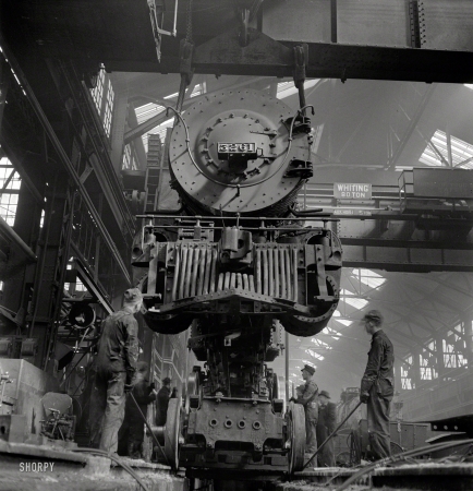Photo showing: Off Track -- March 1943. Topeka, Kansas. Wheeling an engine in the Atchison, Topeka & Santa Fe locomotive shops.