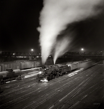 Photo showing: Midnight Special -- March 1943. Argentine, Kansas. Freight train about to leave the Atchison, Topeka & Santa Fe Railroad yard for the West Coast.