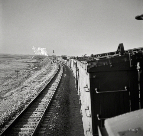 Photo showing: Long Train Going -- March 1943. Canyon, Texas. Approaching the town on the Atchison,
Topeka & Santa Fe Railroad between Amarillo, Texas, and Clovis, New Mexico.