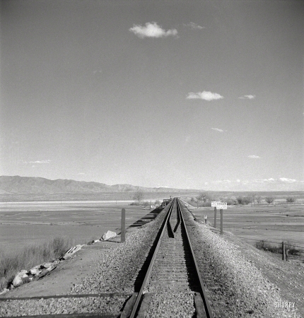 Photo showing: Down to Belen: 1943 -- March 1943. Belen, New Mexico. Going across the Rio Grande River Valley on the
Atchison, Topeka & Santa Fe R.R. between Vaughn and Belen, New Mexico.