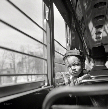 Photo showing: Short Commute -- April 1943. Washington, D.C. Little boy riding on a streetcar.
