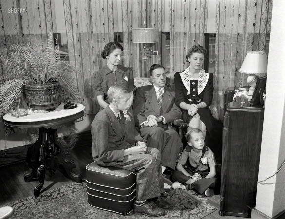 Photo showing: War News. -- September 1942. Rochester, New York. The Babcocks, an American family, tuning in for
war news. Mr. and Mrs. Babcock with children Shirley, Howard and Earl, the youngest.