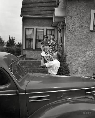Photo showing: Daddys Boy -- Sept. 1942. Rochester, New York. Mrs. Babcock, Shirley and Earl greeting Mr. Babcock in front of the house.