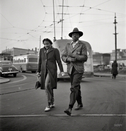 Photo showing: Another Day -- April 1943. Baltimore, Maryland. Workers hurrying to catch a conveyance for their jobs at 7 a.m.