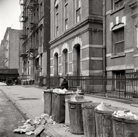 Photo showing: Ashcan Alley -- April 1943. New York street scene in Harlem. Trash cans along the curb.